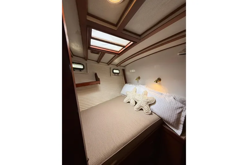 Slide: The Image of Cozy cabin interior of 1982 Krogen 42 yacht with starfish pillows and skylight. - 10