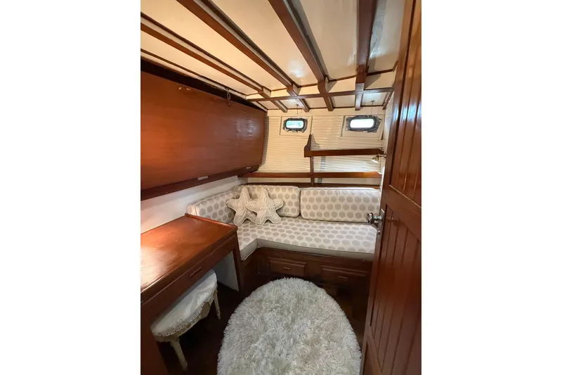 Slide: The Image of Cozy 1982 Krogen 42 yacht cabin with wooden interior and plush seating. - 12