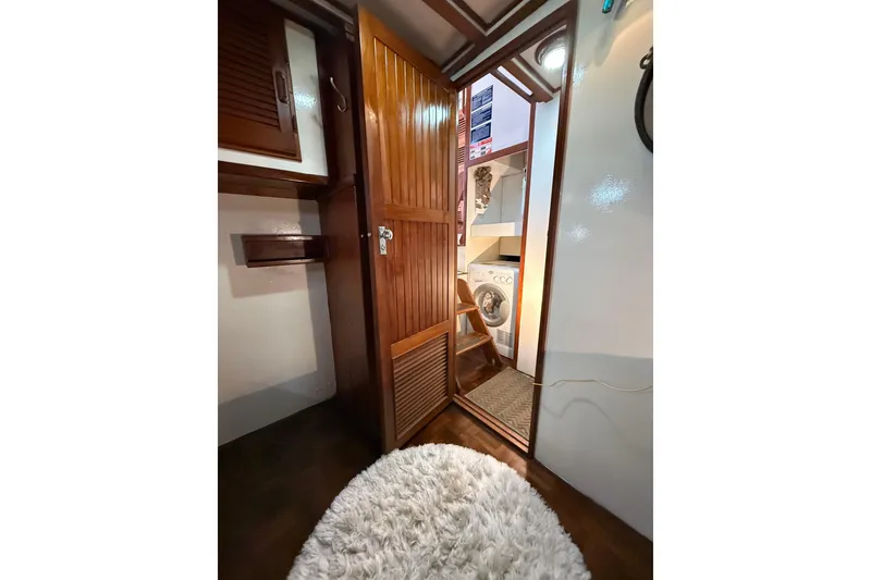 Slide: The Image of Interior of 1982 Krogen 42 yacht with wooden door and washing machine. - 13