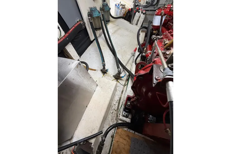 Slide: The Image of Engine room of 1982 Krogen 42 boat with visible machinery and hoses. - 15