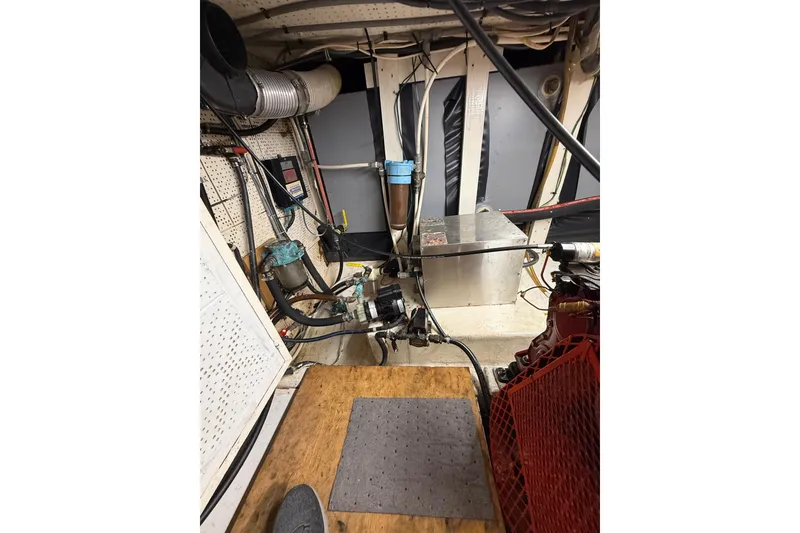 Slide: The Image of Engine room of 1982 Krogen 42 boat with mechanical components and wiring. - 16