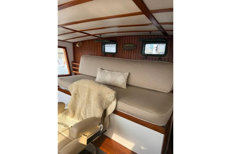 Slide: The Image of Cozy interior of 1982 Krogen 42 boat with cushioned seating and wooden accents. - 22