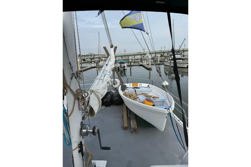 Slide: The Image of 1982 Krogen 42 boat docked at marina with dinghy and nautical equipment. - 25