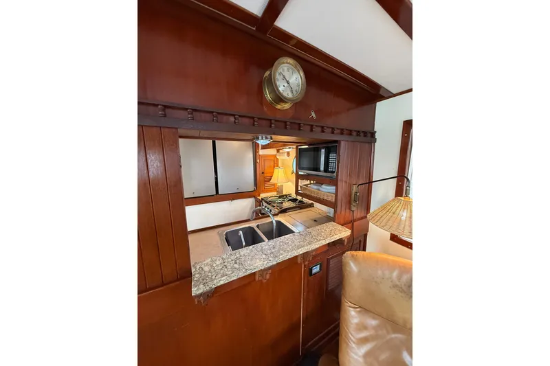 Slide: The Image of Interior of 1982 Krogen 42 yacht featuring a compact kitchen with wooden cabinetry. - 7
