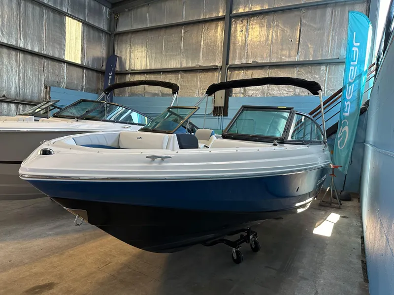 The Image of 2025 Regal 2000 ESX Bowrider in a garage on blue tarp. - 0