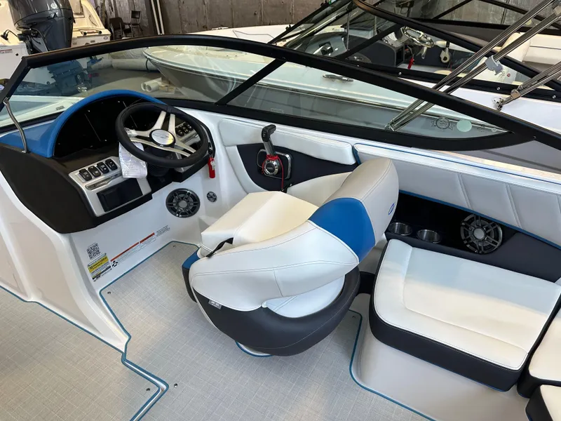 Slide: The Image of 2025 Regal 2000ES Bowrider interior with white and blue seating, showcased indoors. - 10