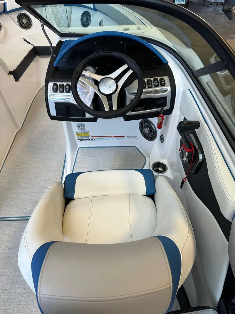 Slide: The Image of 2025 Regal 2000ES Bowrider interior with white seating and modern design. - 11