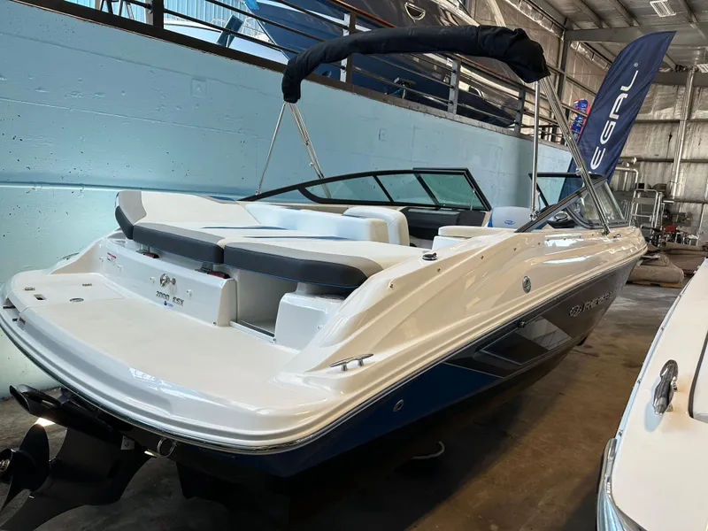 Slide: The Image of 2025 Regal 2000ES Bowrider boat displayed in a showroom. - 3