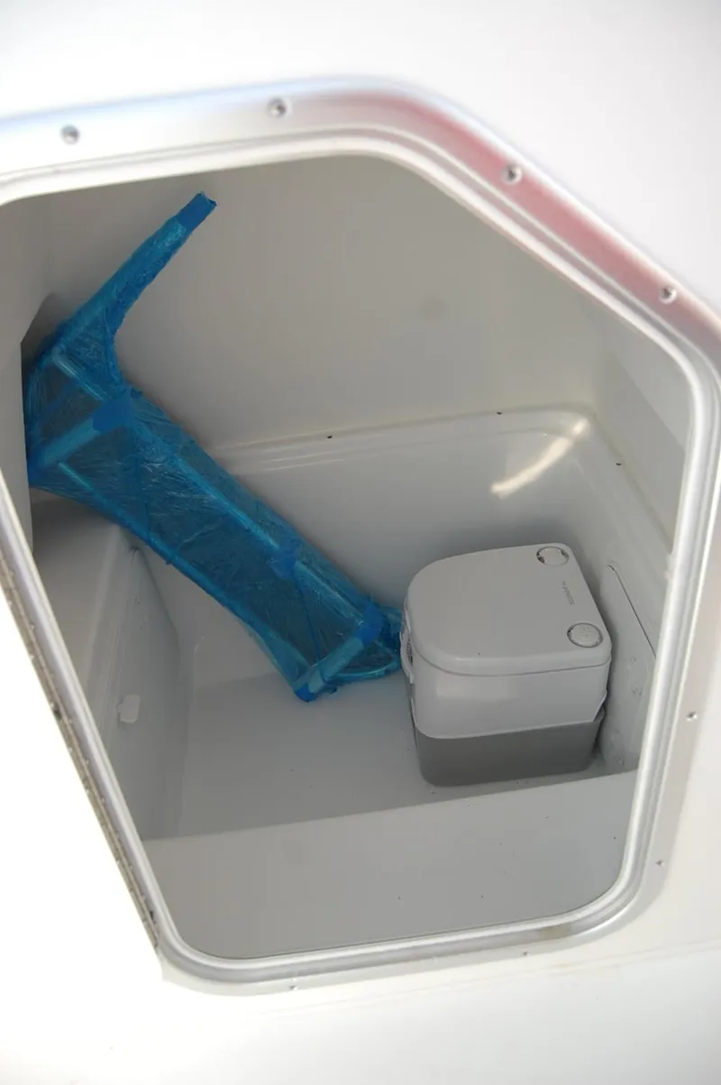 Slide: The Image of 2024 Cape Horn 24 XS boat storage compartment with portable toilet. - 12