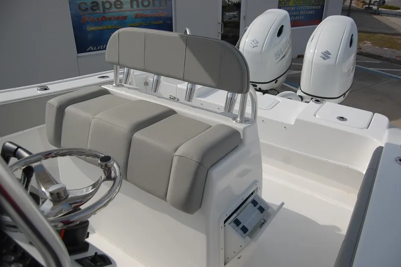 Slide: The Image of 2024 Cape Horn 24 XS boat with dual outboard engines and cushioned seating. - 16