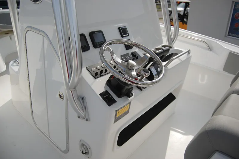Slide: The Image of 2024 Cape Horn 24 XS boat console with steering wheel and controls. - 17