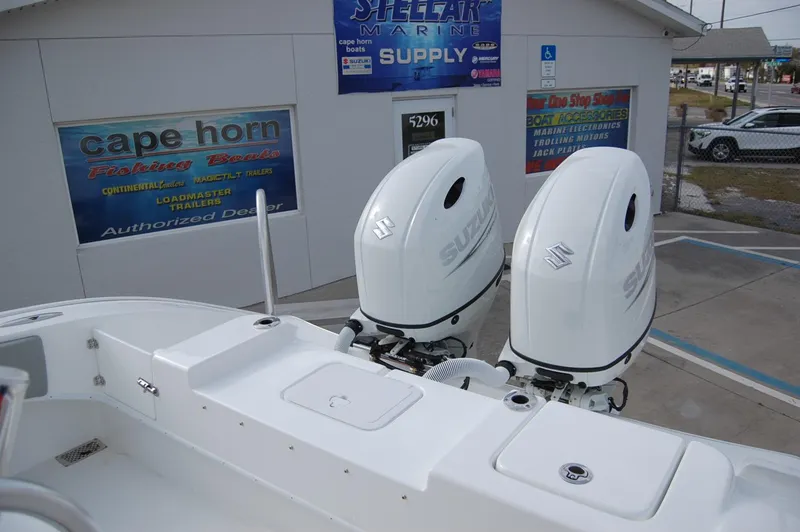 Slide: The Image of 2024 Cape Horn 24 XS boat with dual Suzuki outboard motors at dealership. - 20