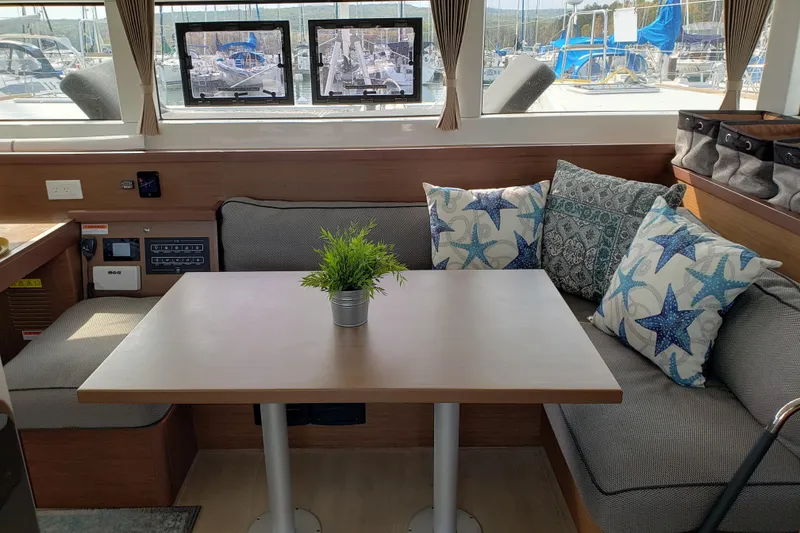 Slide: The Image of Cozy interior of 2019 Lagoon 40 catamaran with starfish-themed cushions and potted plant. - 11