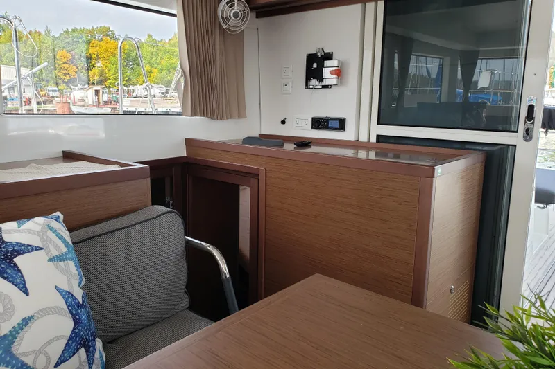 Slide: The Image of Interior of 2019 Lagoon 40 catamaran with modern wood finish and comfortable seating. - 12