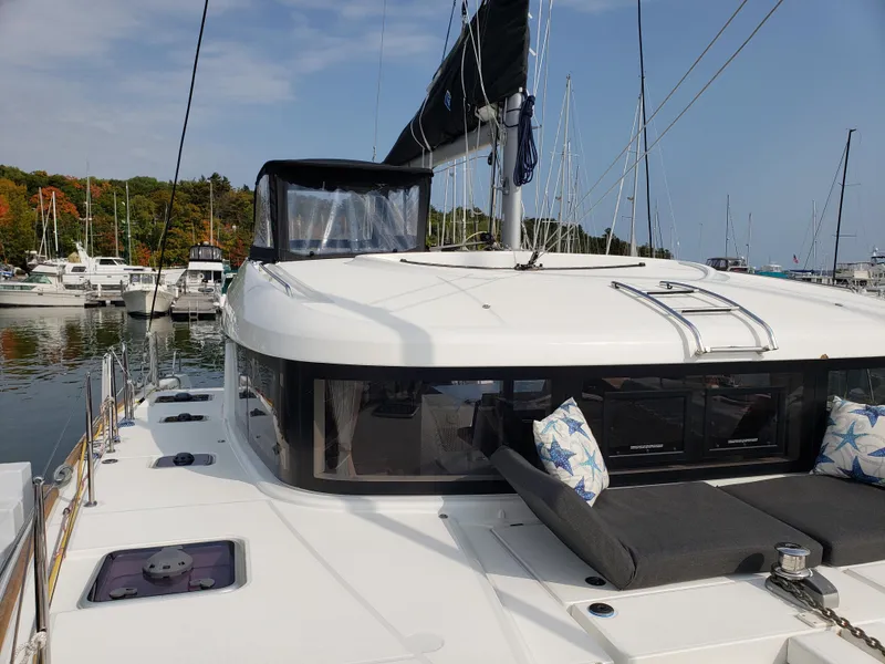 Slide: The Image of 2019 Lagoon 40 catamaran docked at marina with scenic background. - 13