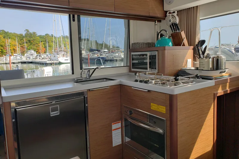 Slide: The Image of Modern kitchen in a 2019 Lagoon 40 catamaran with marina view. - 14