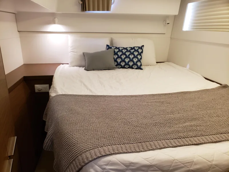 Slide: The Image of Cozy bedroom interior of 2019 Lagoon 40 yacht with stylish bedding and cushions. - 15