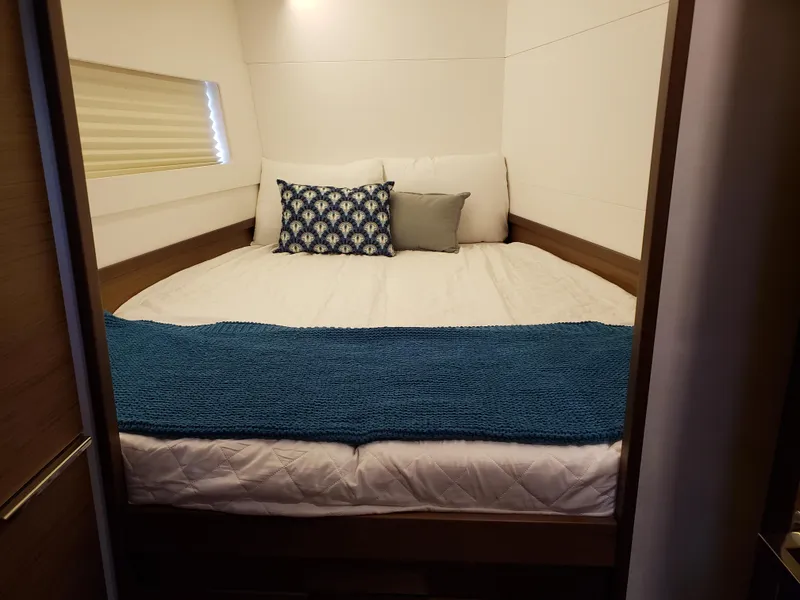 Slide: The Image of Cozy bedroom in 2019 Lagoon 40 yacht with blue accents and pillows. - 16