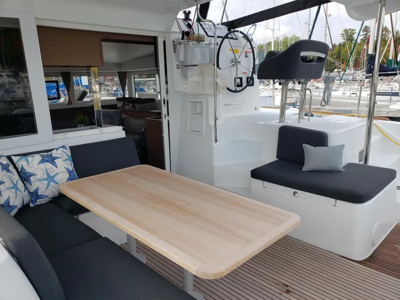 Slide: The Image of Spacious 2019 Lagoon 40 catamaran cockpit with seating, table, and helm station. - 3