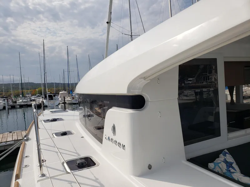Slide: The Image of 2019 Lagoon 40 catamaran docked at marina, showcasing sleek design and modern features. - 6