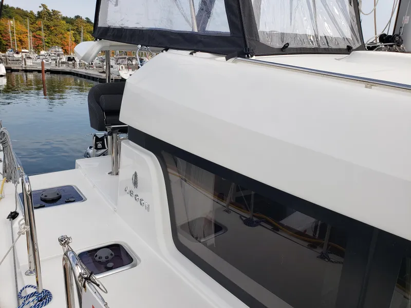 Slide: The Image of 2019 Lagoon 40 catamaran docked at marina, showcasing sleek design and modern features. - 7
