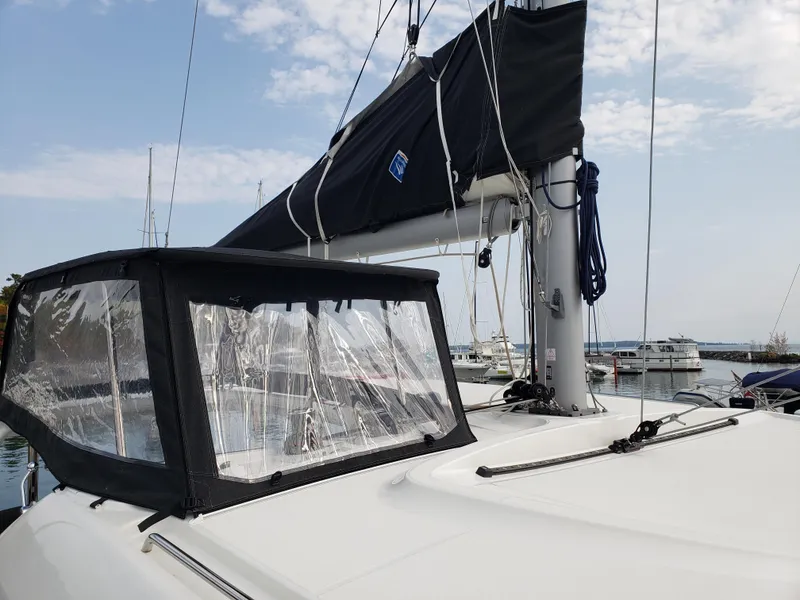 Slide: The Image of 2019 Lagoon 40 catamaran with black sail cover docked at marina. - 8