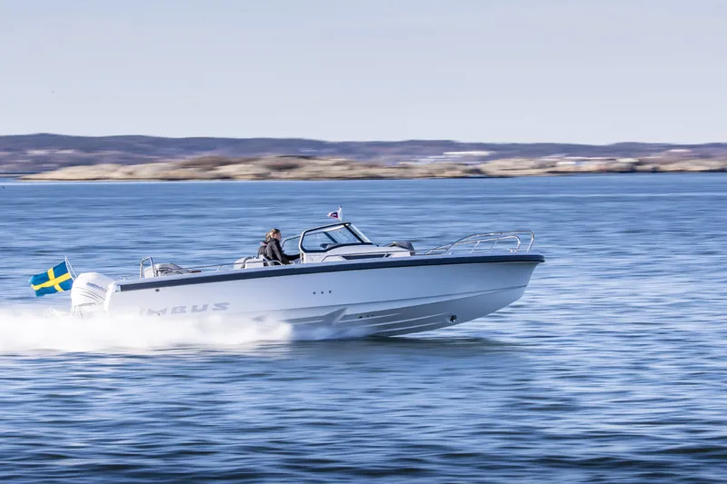 Slide: The Image of Nimbus T9 2025 motorboat speeding on open water with Swedish flag. - 11