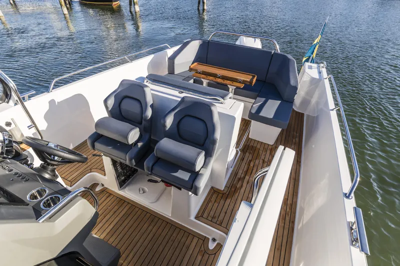 Slide: The Image of Interior of 2025 Nimbus T9 boat with seating and wooden deck. - 1