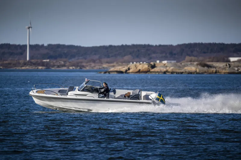 Slide: The Image of Nimbus T9 boat cruising on water, 2025 model, scenic coastal background. - 10