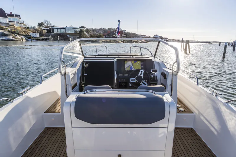 Slide: The Image of Nimbus T9 2025 boat cockpit with navigation system on calm waters. - 4