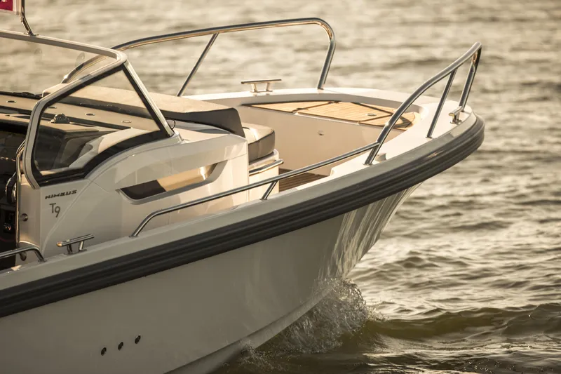 Slide: The Image of 2025 Nimbus T9 boat cruising on water, close-up of bow and deck. - 9