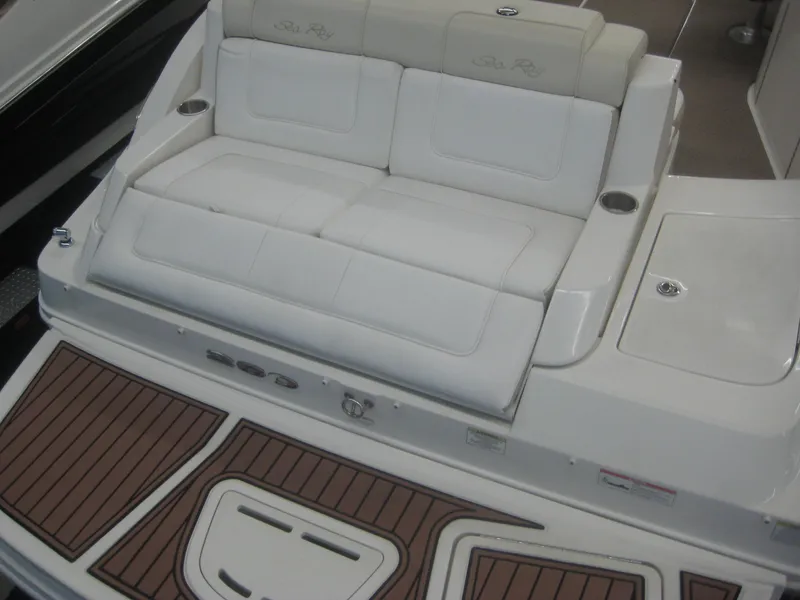 Slide: The Image of The image shows the stern of a Sea Ray 260 Sundeck boat with white seating and teak-like flooring. - 8