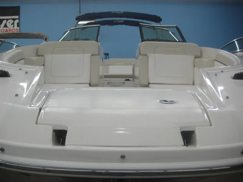 Slide: The Image of The image shows the stern of a 2013 Sea Ray 260 Sundeck boat with white seating. - 5