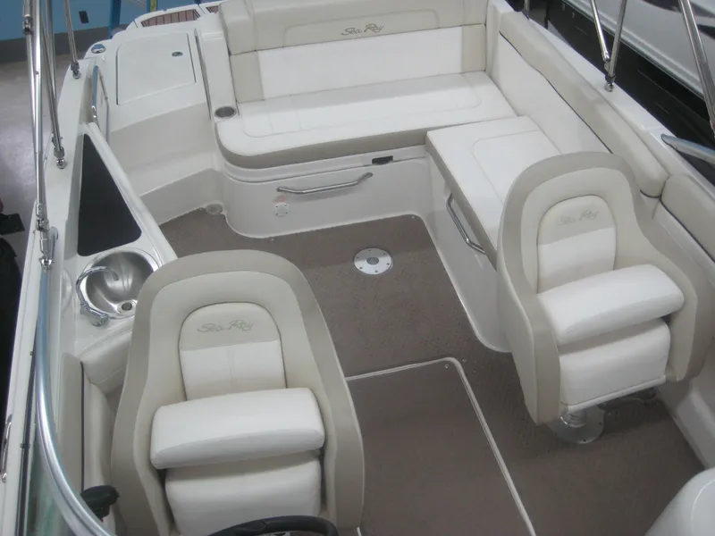 Slide: The Image of The image shows the cockpit of a Sea Ray 260 Sundeck boat with beige and white seating. - 2
