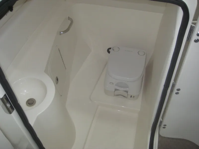 Slide: The Image of The image shows a compact boat toilet with a small sink and a portable toilet. - 15