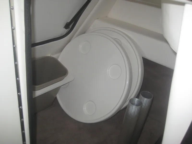 Slide: The Image of Interior of a 2013 Sea Ray 260 Sundeck with storage space and round covers. - 19