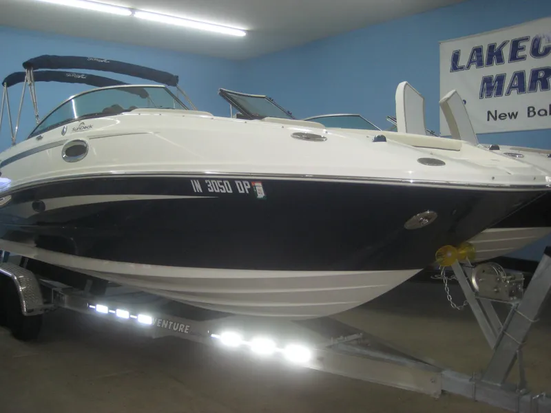 Slide: The Image of A 2013 Sea Ray 260 Sundeck boat on a trailer in a showroom. - 0
