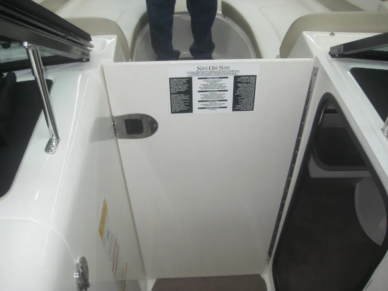 Slide: The Image of The 2013 Sea Ray 260 Sundeck features an open cabin door with a warning label. - 18