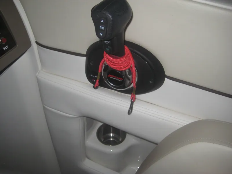 Slide: The Image of Close-up of a throttle lever with red safety cord in a Sea Ray 260 Sundeck boat. - 16