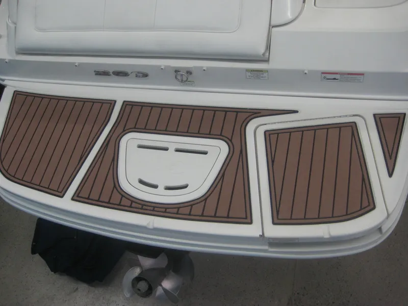 Slide: The Image of The 2013 Sea Ray 260 Sundeck swim platform features a sleek design with brown accents. - 9