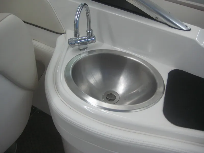 Slide: The Image of A stainless steel sink with a faucet in a white boat interior. - 17