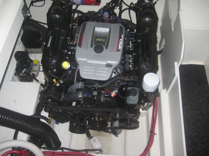 Slide: The Image of The engine compartment of a 2013 Sea Ray 260 Sundeck features a neatly installed engine. - 25