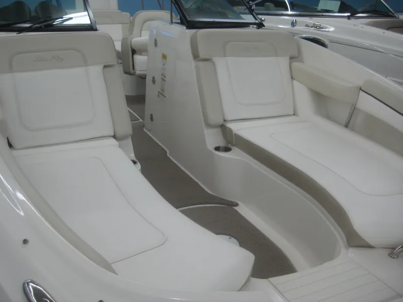 Slide: The Image of The image shows the cockpit of a Sea Ray 260 Sundeck boat with white seating. - 7