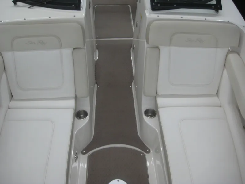 Slide: The Image of Interior view of a 2013 Sea Ray 260 Sundeck with white seating and gray carpet. - 14