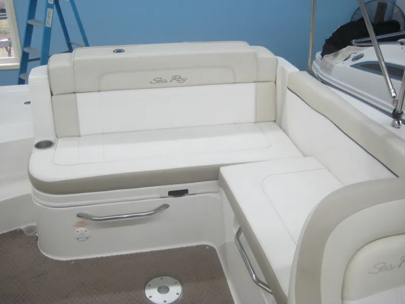 Slide: The Image of The 2013 Sea Ray 260 Sundeck features an elegant cream-colored bench seat with padded backrests. - 12