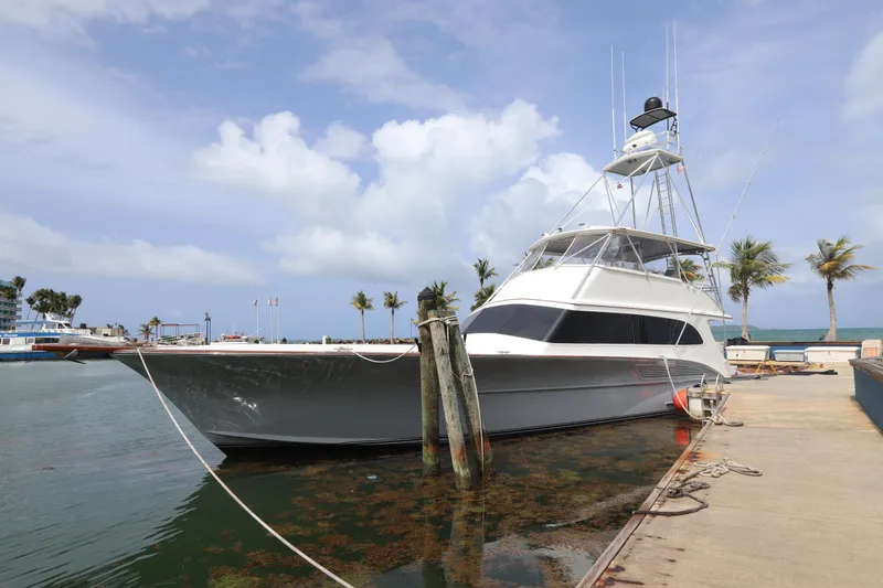 The Image of Luxury 2002 Buddy Davis 74 yacht docked at marina under clear sky. - 0