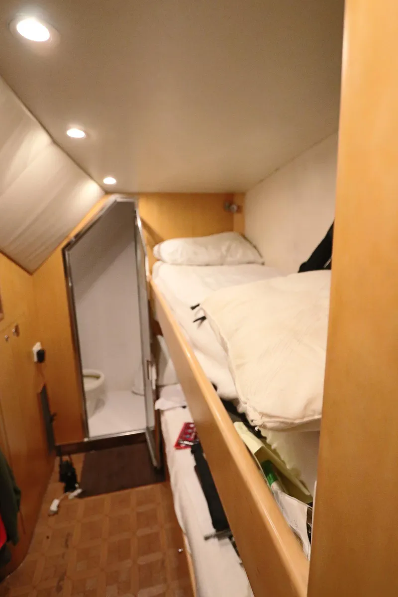 Slide: The Image of Interior of 2002 Buddy Davis 74 yacht with bunk beds and compact bathroom. - 11