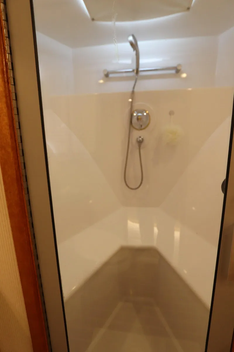 Slide: The Image of Shower area inside a 2002 Buddy Davis 74 yacht, featuring modern fixtures and sleek design. - 19
