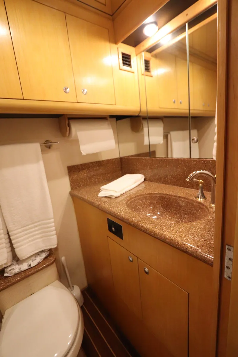 Slide: The Image of Luxurious bathroom in 2002 Buddy Davis 74 yacht with wood cabinetry and granite countertop. - 23