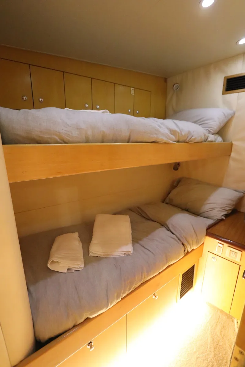 Slide: The Image of Bunk beds in 2002 Buddy Davis 74 yacht cabin with cozy bedding and warm lighting. - 24